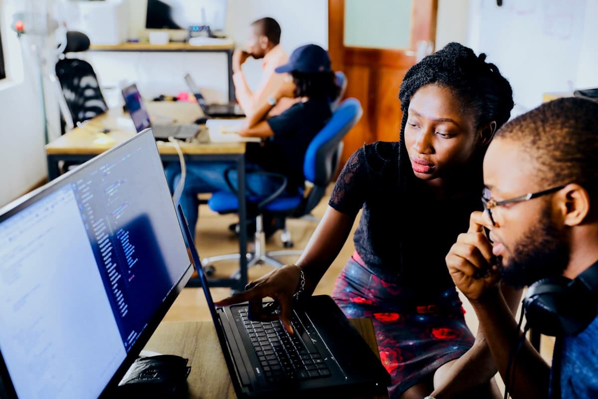 School administrators collaborating around a computer